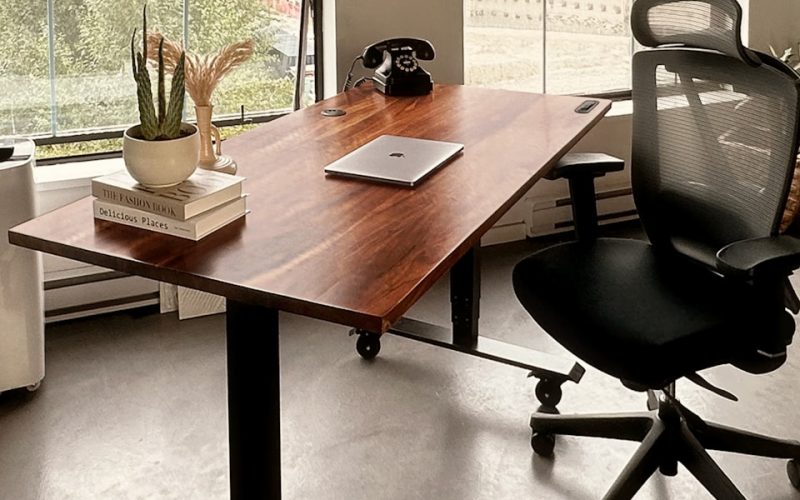 a desk with a laptop on it in an office